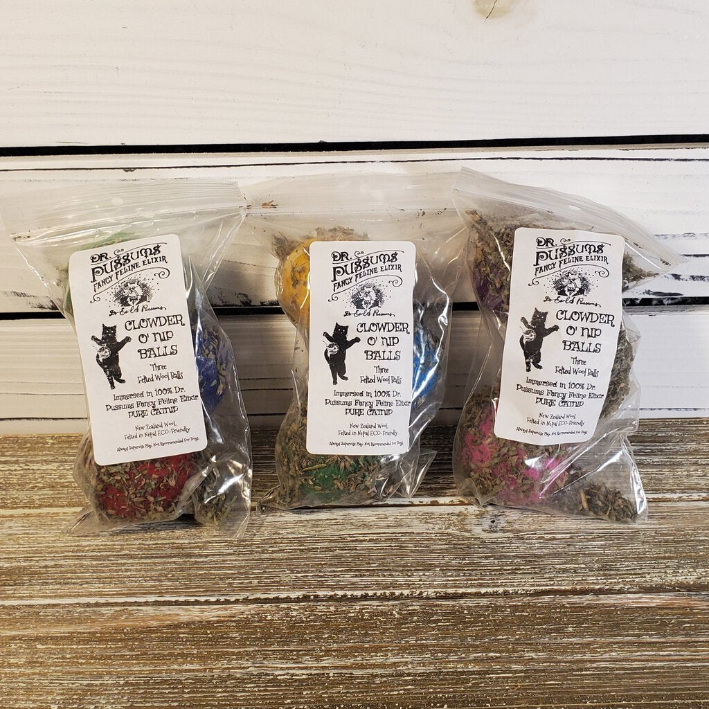 Three sealed plastic packages of Catnip O Nip Balls, each with a different color of catnip balls visible inside.