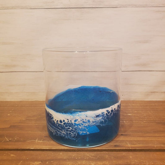 A clear lowball glass with a blue and white ocean-inspired design on the exterior, intended for whiskey cocktails.