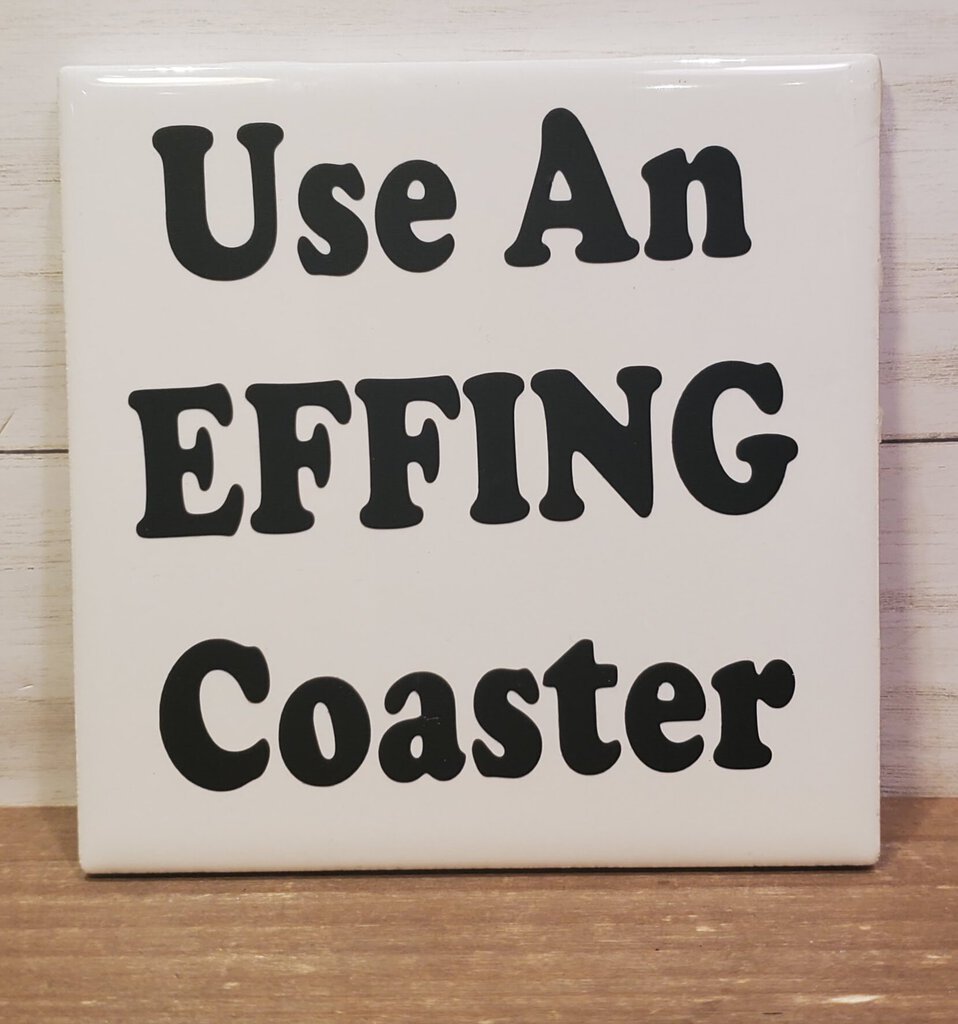 A white ceramic coaster with black text that reads 'Use An EFFING Coaster'.