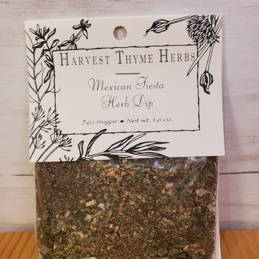 Packaging of Mexican Fiesta Herb Dip by Harvest Thyme Herbs, showing a clear window with the dip mix inside, and a black and white label with text and decorative elements.