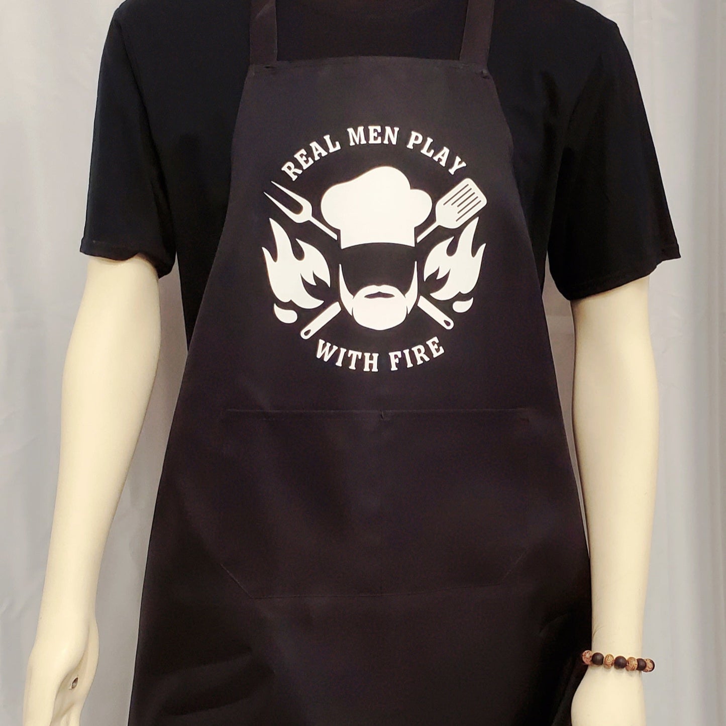 Black apron with white graphic and text worn by a mannequin against a plain background
