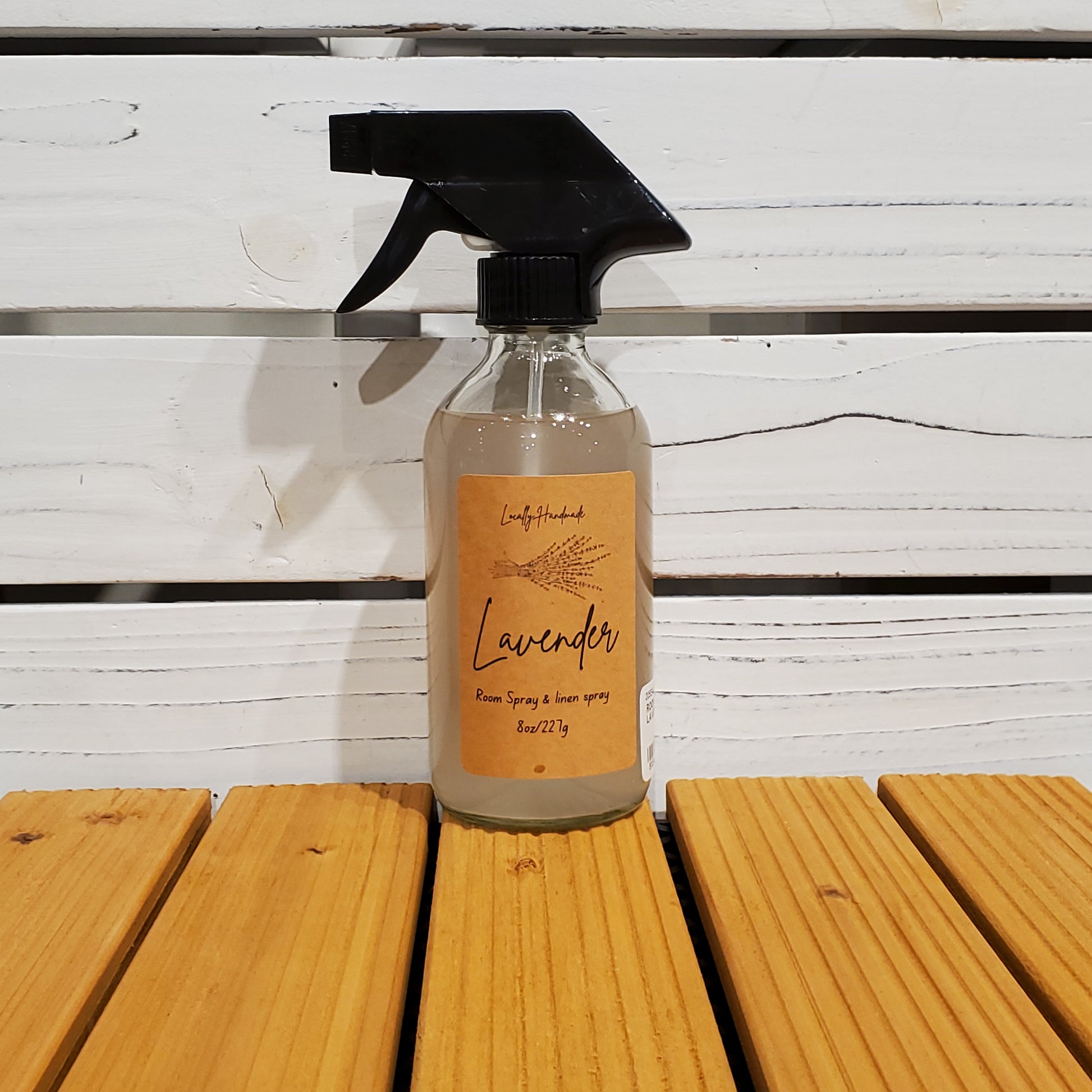 Bottle of lavender spray on a wooden surface