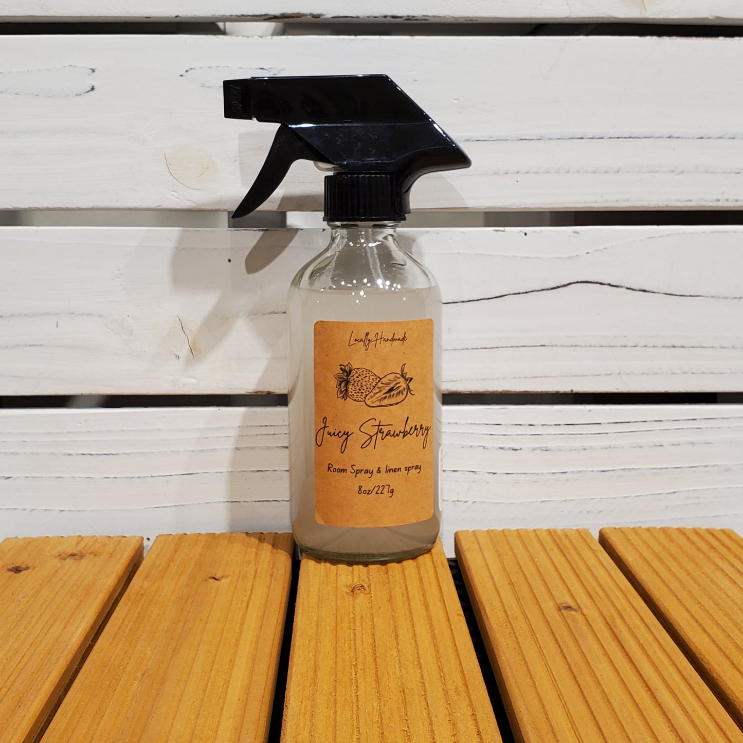 Bottle of Jerry Strawberry cleaner on a wooden surface