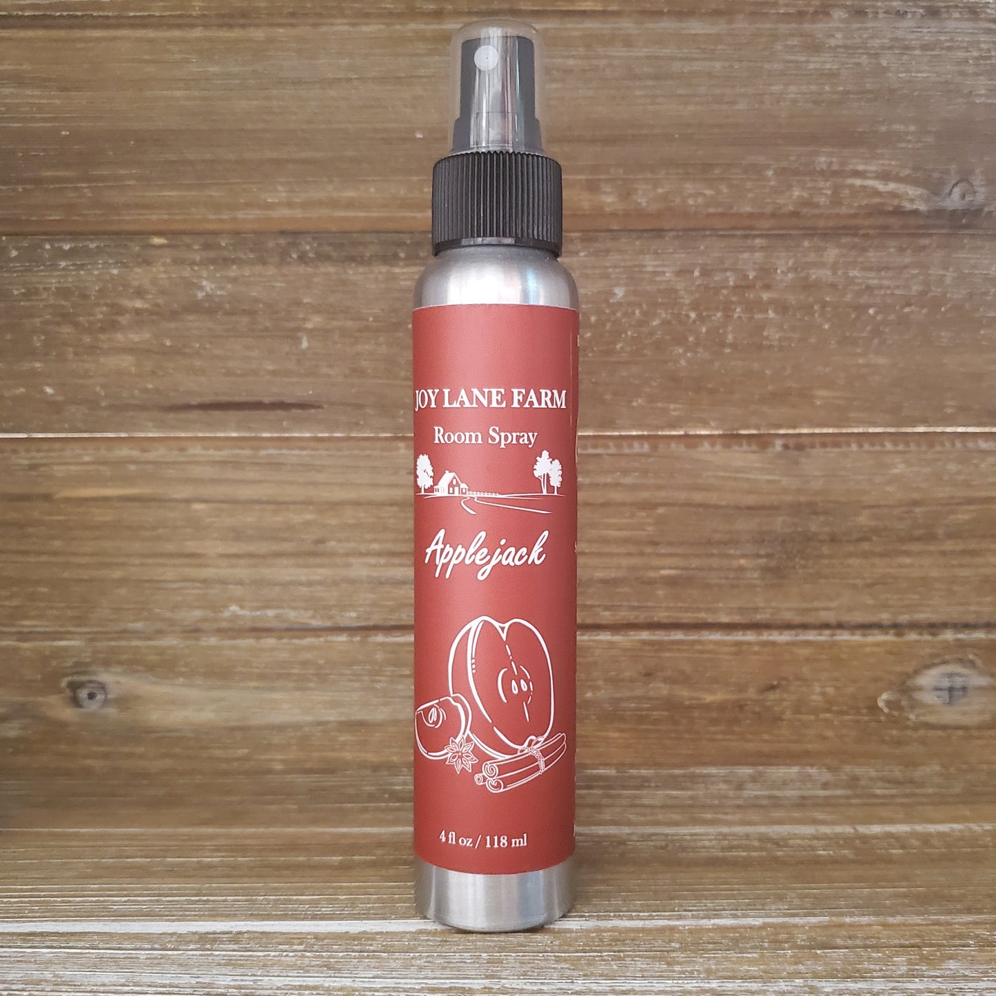 Room spray bottle labeled 'Apple Jack' from 'Dy Lane Farm' on a wooden background