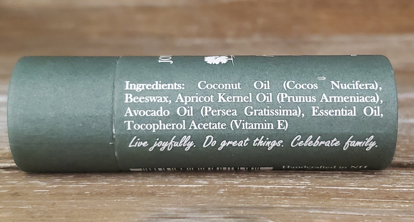 Green cylindrical container with text on a wooden surface