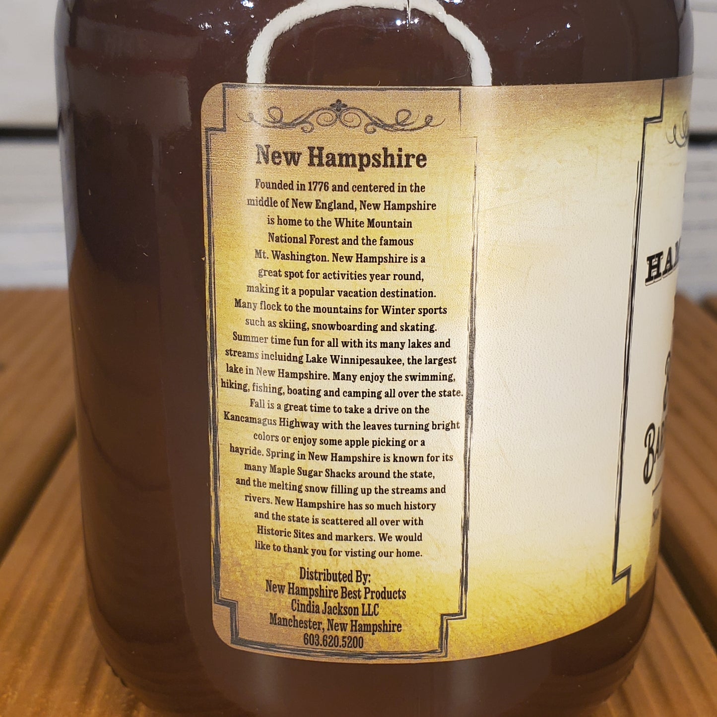 Bottle label with text about New Hampshire on a wooden surface