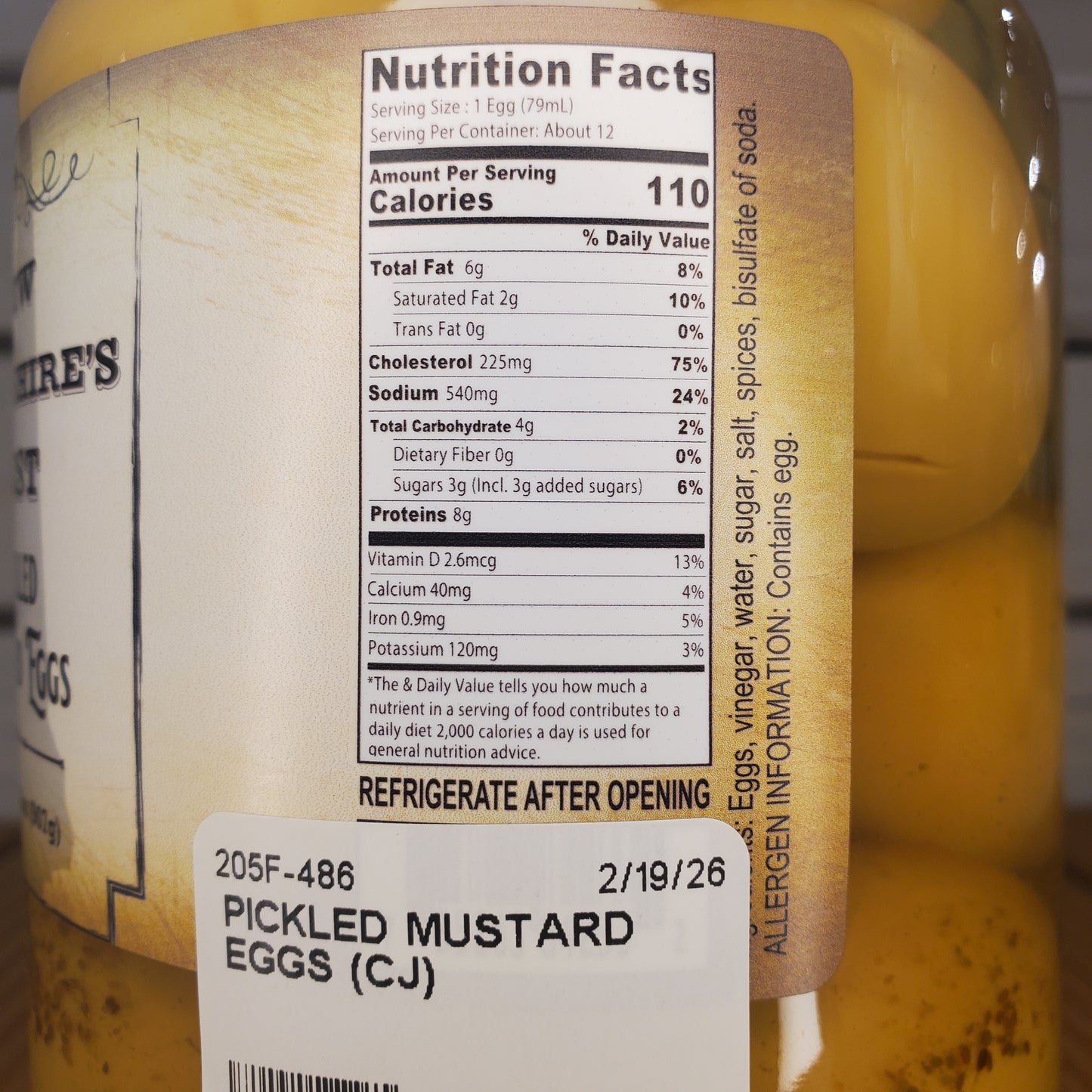 Close-up of pickled mustard eggs with a label showing nutrition facts and storage instructions.