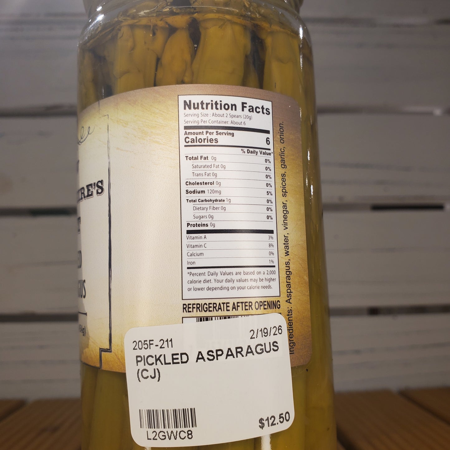 Pickled asparagus jar with label and nutrition facts on a white background