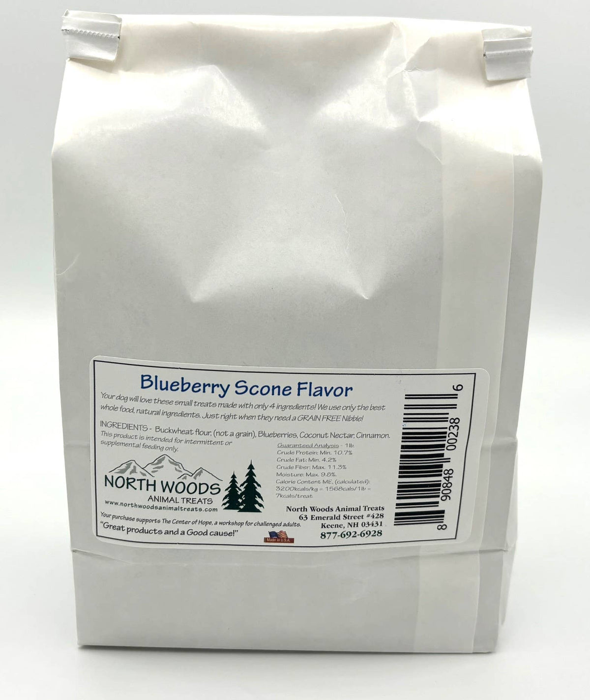 A white paper bag of North Woods Natural Products Blueberry Scone Flavor edible flour, showing the back label with product details and a barcode.
