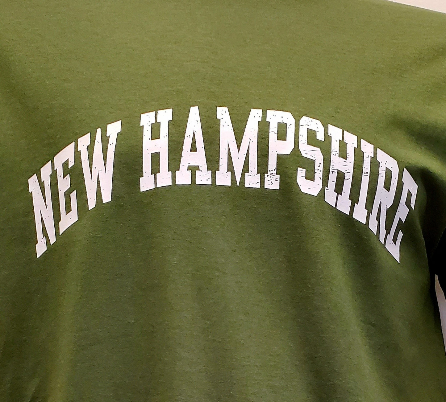 Green t-shirt with 'NEW HAMPSHIRE' printed in white text