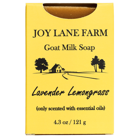 A yellow rectangular box of Joy Lane Farm Goat Milk Soap, specifically the Lavender Lemongrass scent. The box features black text and a simple black line drawing of a farm scene with trees and a house.