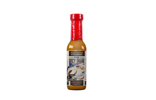 Bottle of spicy sauce with a red cap on a white background