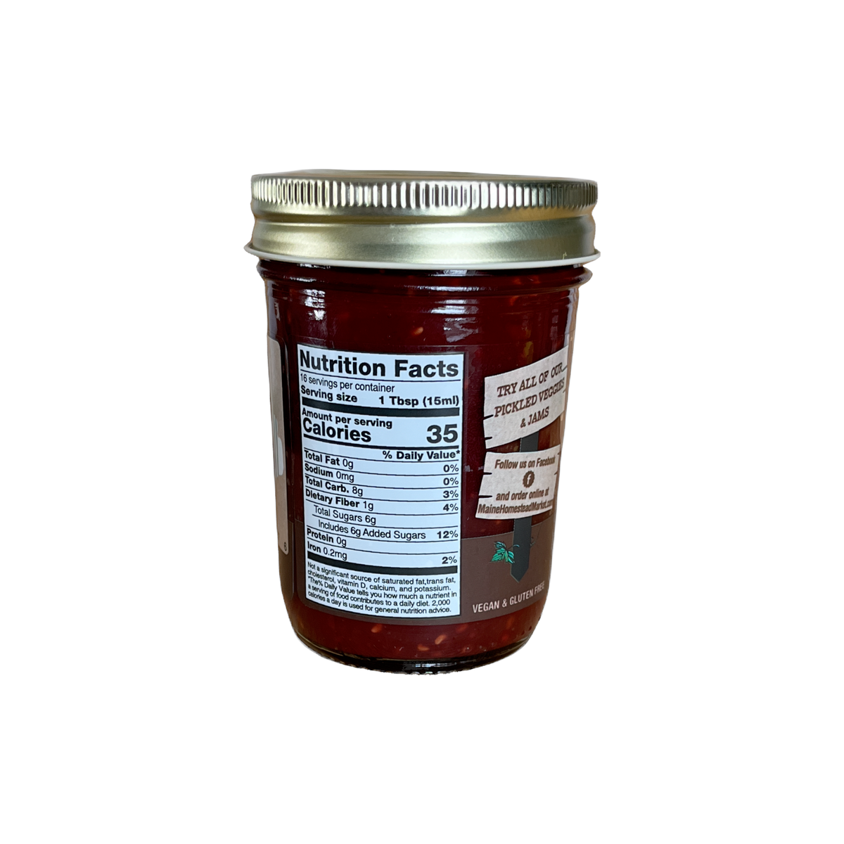 A glass jar of red jam with a silver metal lid, showing a Nutrition Facts label on the front, set against a plain white background.
