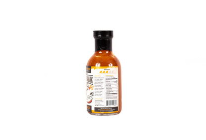 A bottle of hot sauce shown from the back, featuring a black cap and a white label with orange and black text, isolated on a white background.