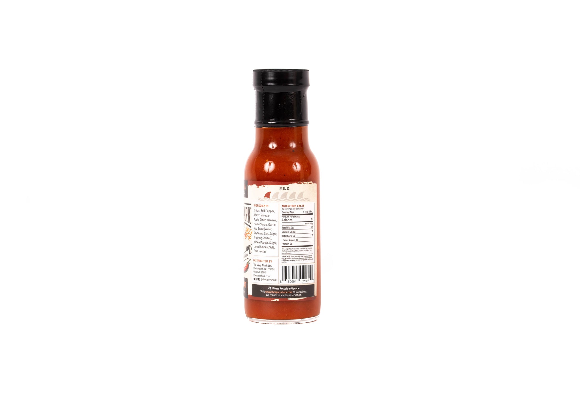 A bottle of hot sauce shown from the back, featuring a black cap and a white label with red and black text, set against a plain white background.