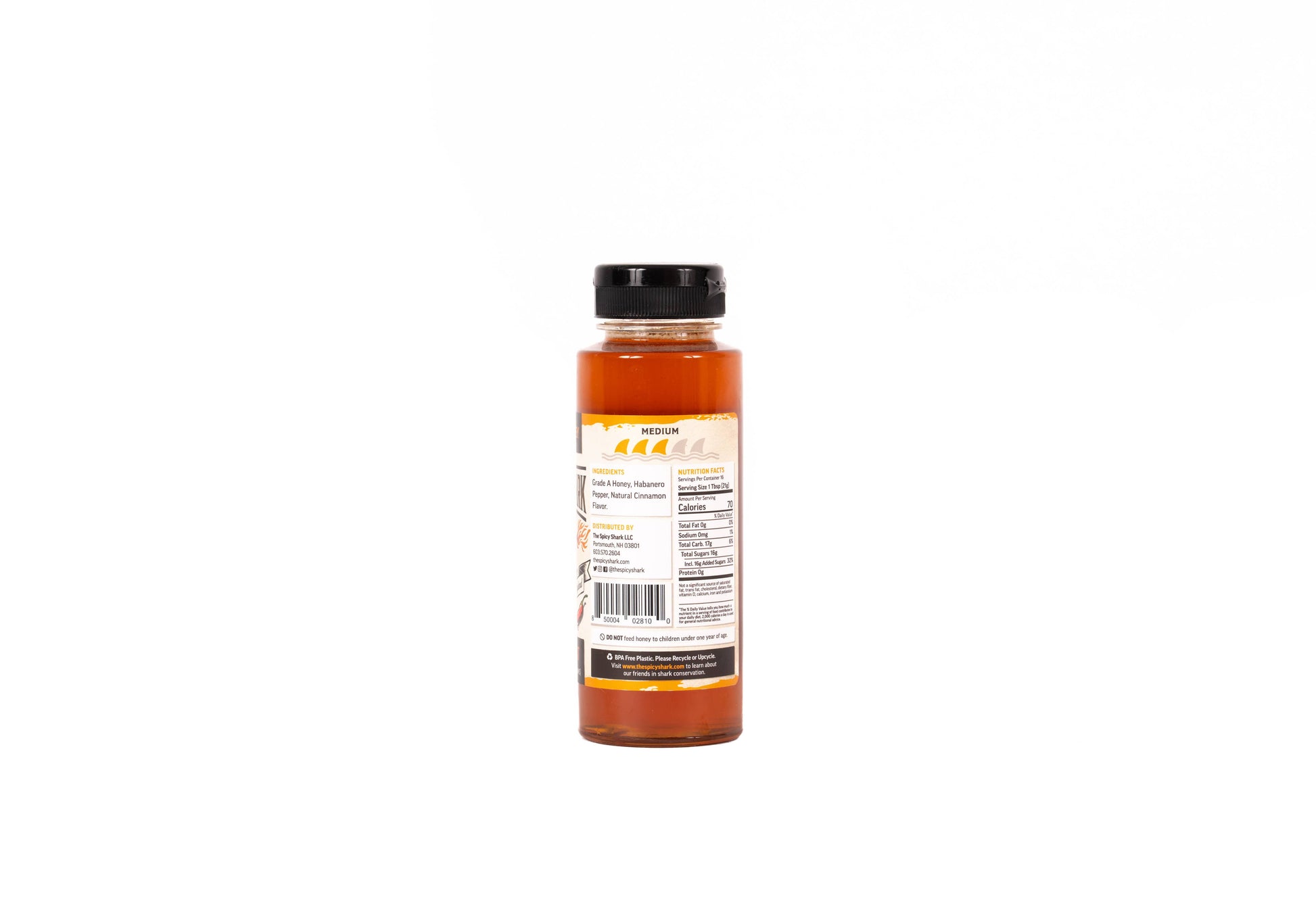 A bottle of hot sauce shown from the back, featuring a black cap and a cream-colored label with orange and black text, set against a plain white background.