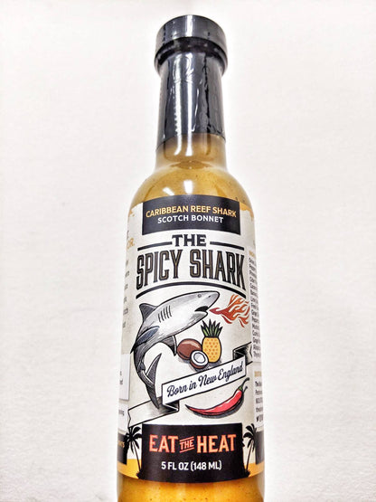 Bottle of 'The Spicy Shark' hot sauce on a white background
