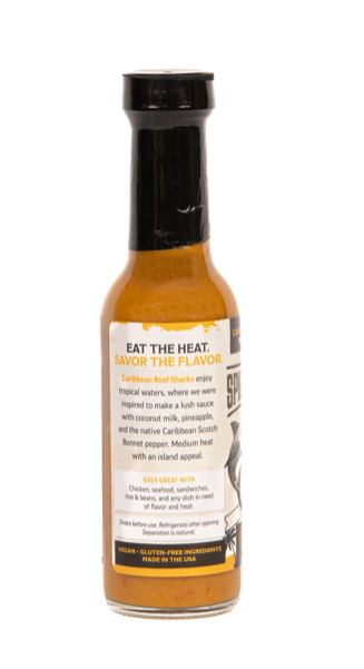 Bottle of hot sauce with label on a white background