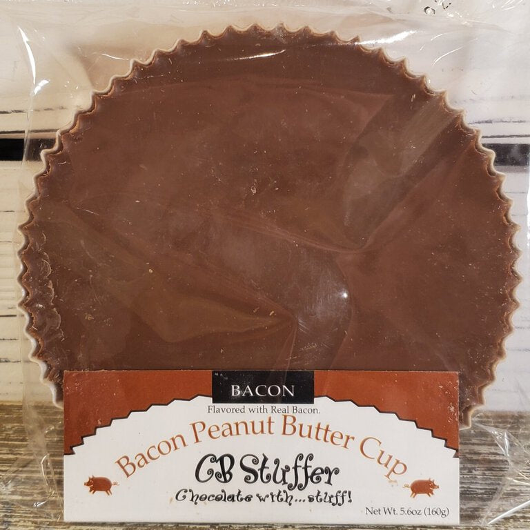 A wrapped bacon peanut butter cup with visible bacon pieces on top.