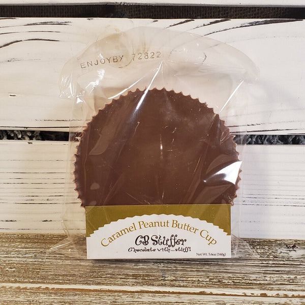 A wrapped Caramel Milk Chocolate Peanut Butter Cup with the brand name 'GB Stuffers' visible on the label.