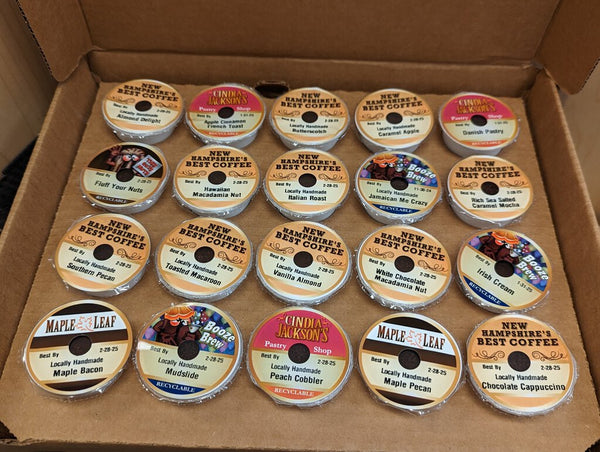 A variety of K-Cups displayed in an open box, showing different coffee flavors.