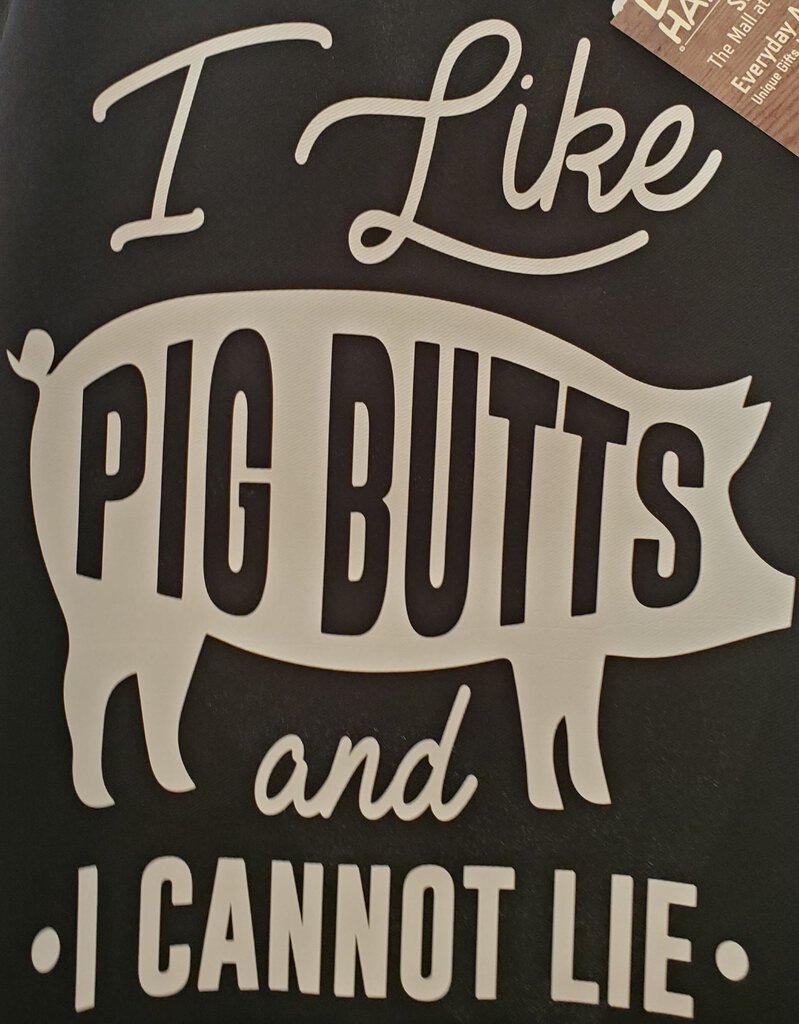This image features a black apron with a bold, white text that reads, "I like Pig Butts and cannot lie." The simple, eye-catching design makes it a playful addition to any kitchen accessory collection.