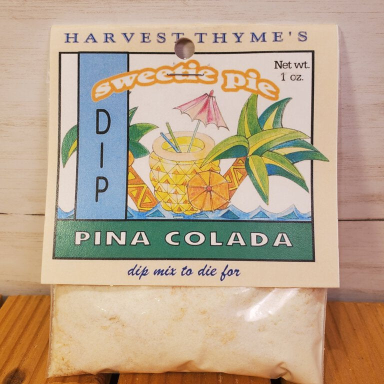 Pina Colada dip mix package with pineapple and umbrella illustration on a wooden surface