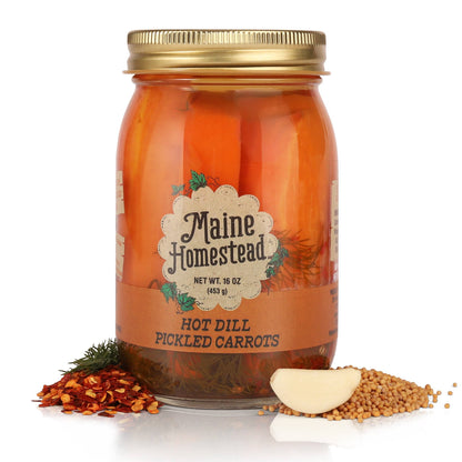 Jar of Maine Homestead hot dill pickled carrots with ingredients on a white background