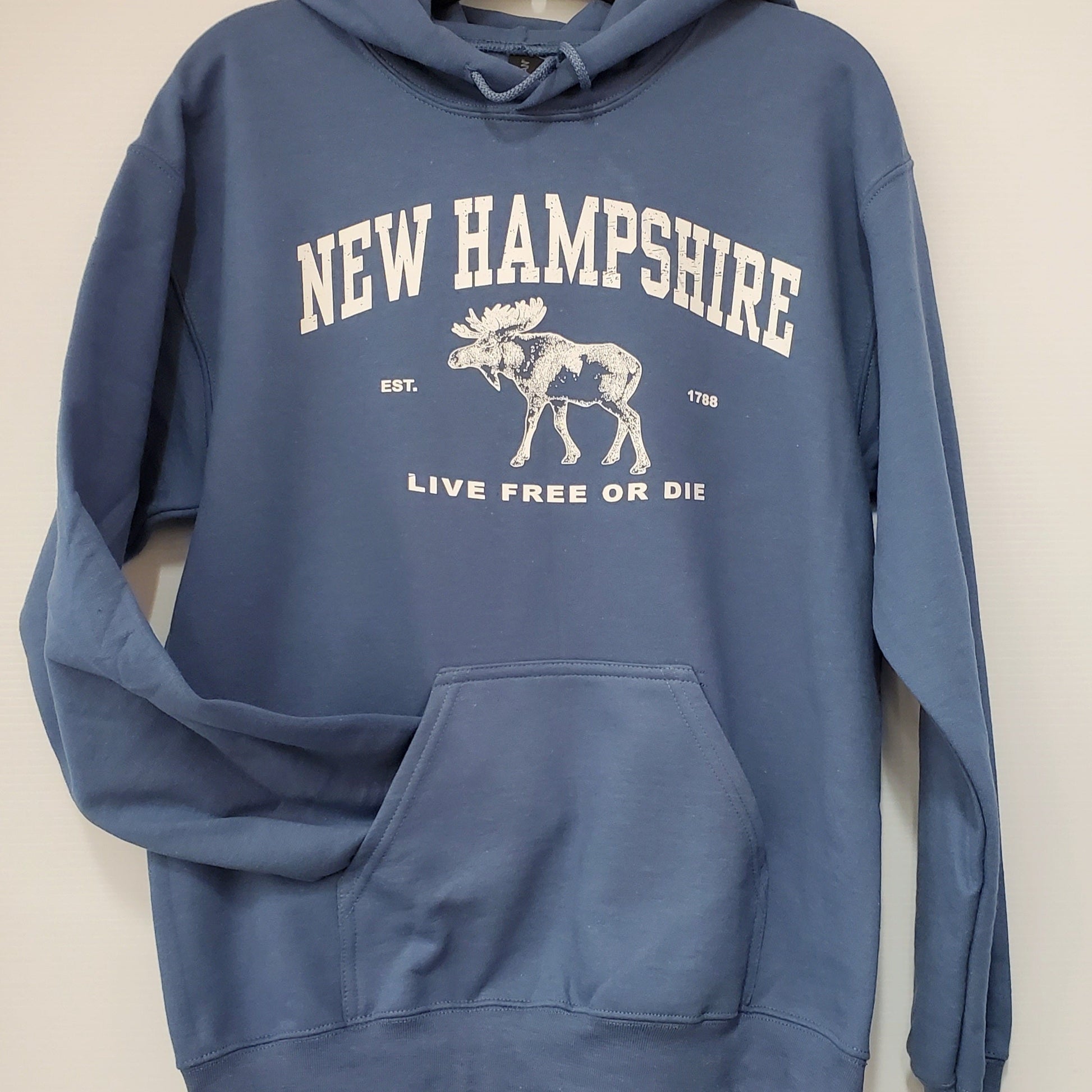 Blue hoodie with 'New Hampshire Live Free or Die' text and moose graphic on a white background