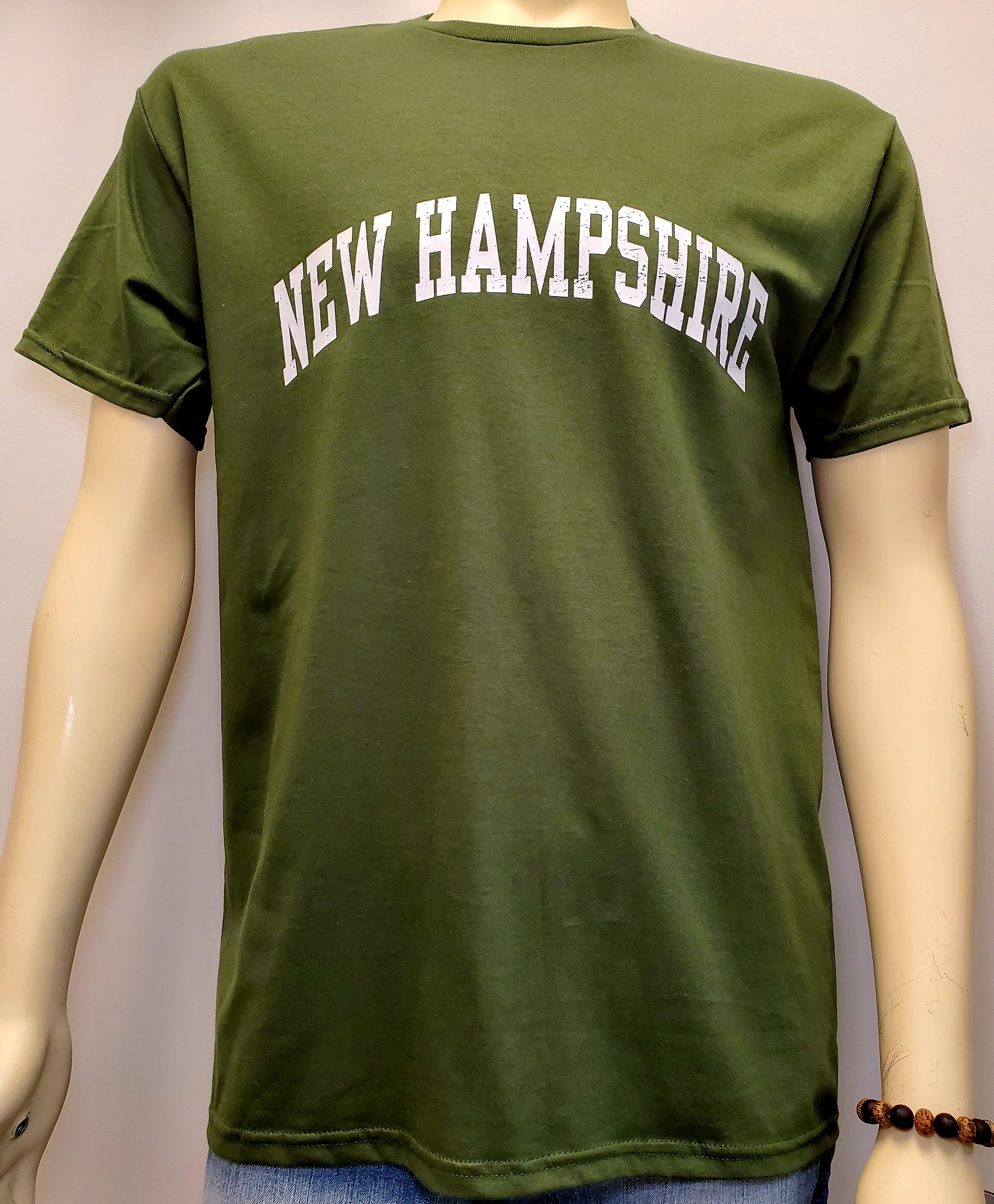 Green t-shirt with 'NEW HAMPSHIRE' text on a mannequin against a plain background