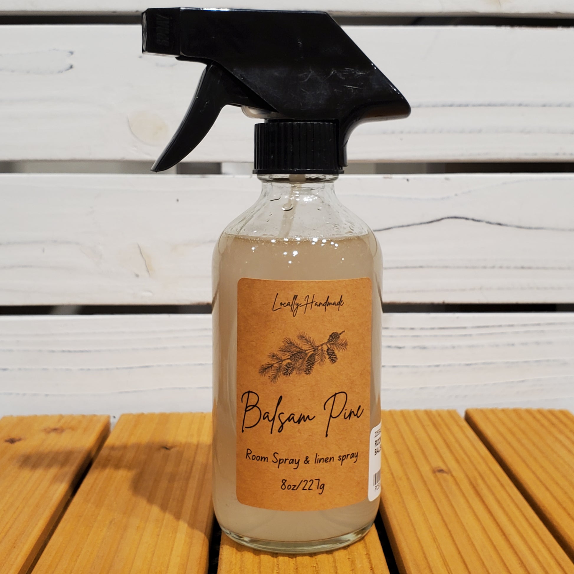 Bottle of Bayou朴 room spray with a label on a wooden surface