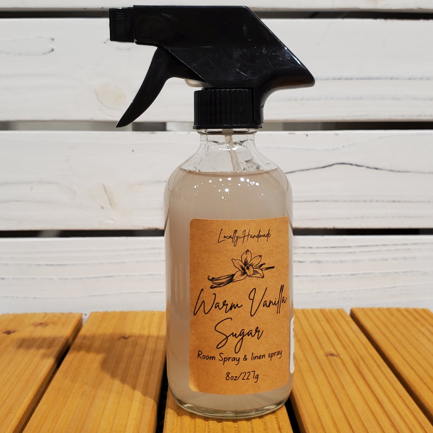 Spray bottle with a label on a wooden surface
