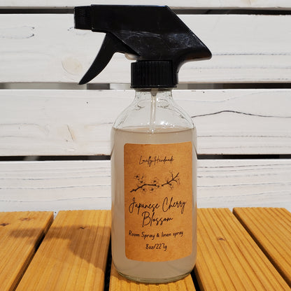 Clear spray bottle with a brown label on a wooden surface