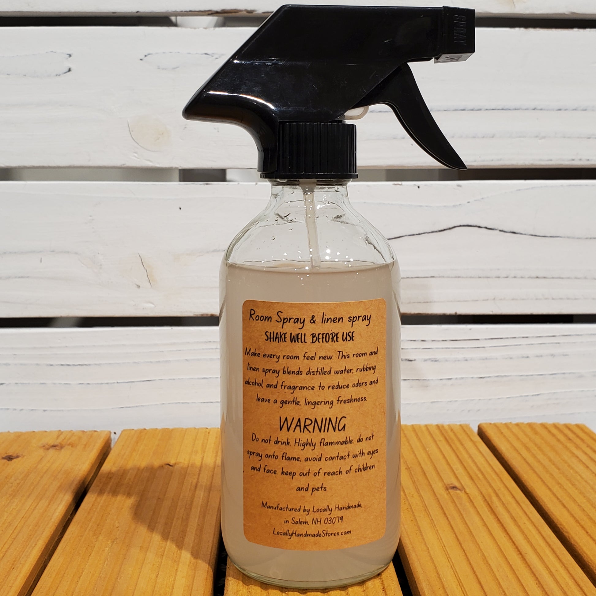 Spray bottle with a label on a wooden surface