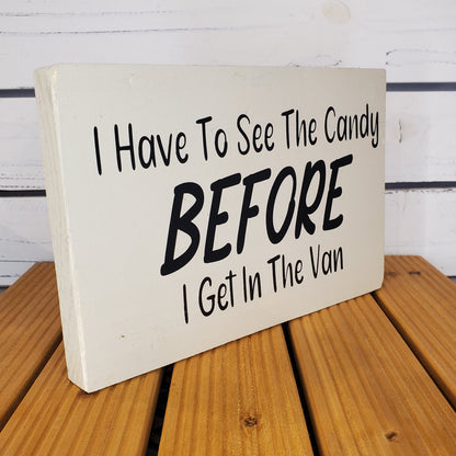 Wooden sign with humorous text on a wooden surface