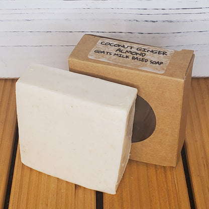 Bar of soap with a cardboard box labeled 'Coconut Almond' on a wooden surface.