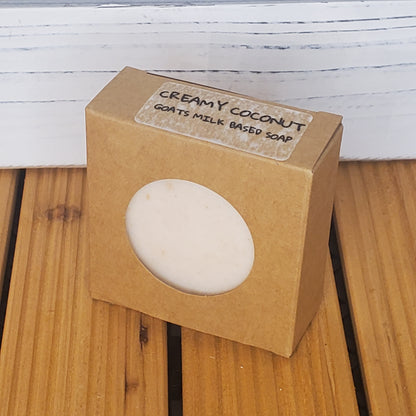 Bar of soap in a brown cardboard box on a wooden surface