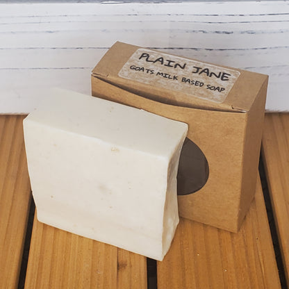 Bar of soap with a cardboard box labeled 'Plain Jane' on a wooden surface.