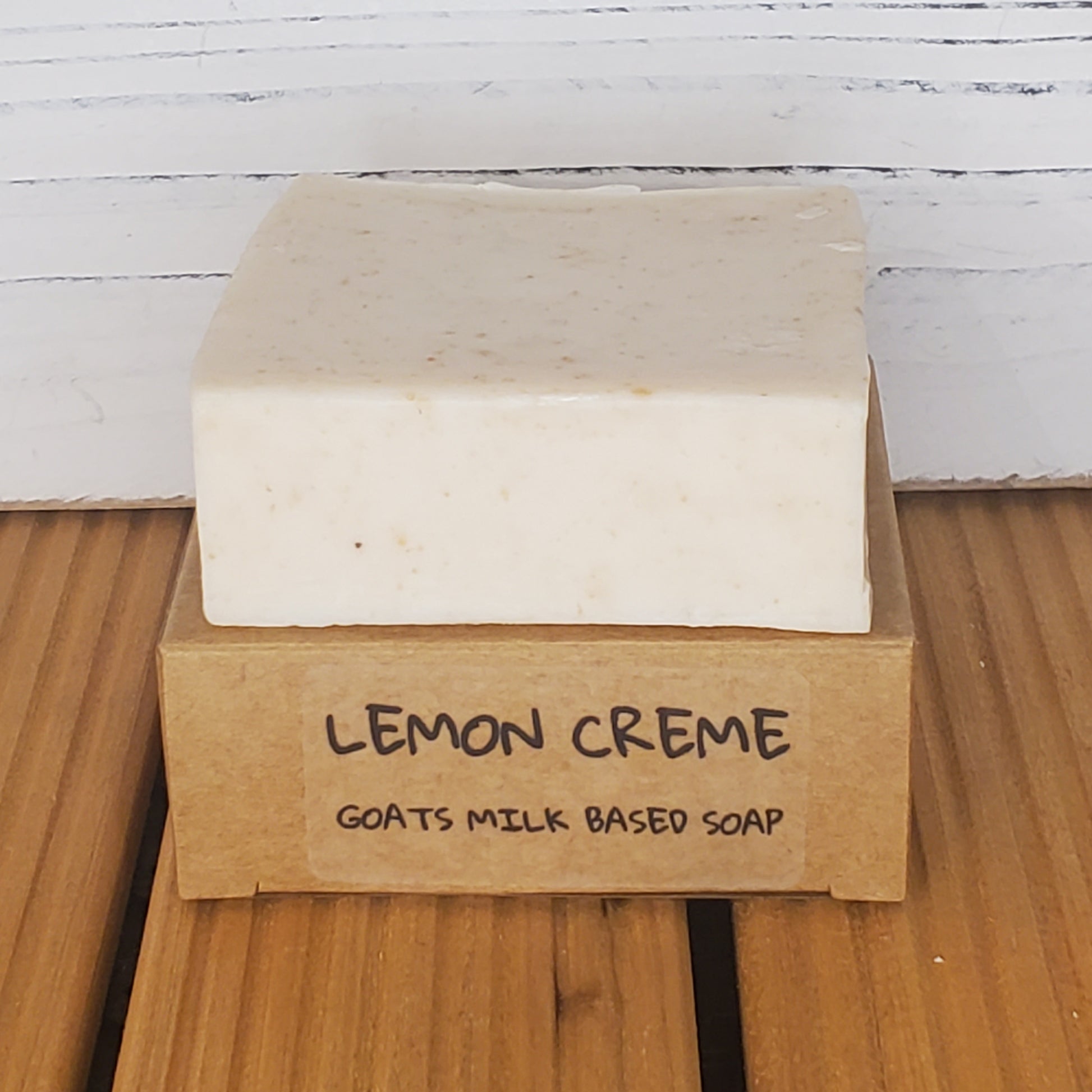 Bar of soap with a brown label on a wooden surface