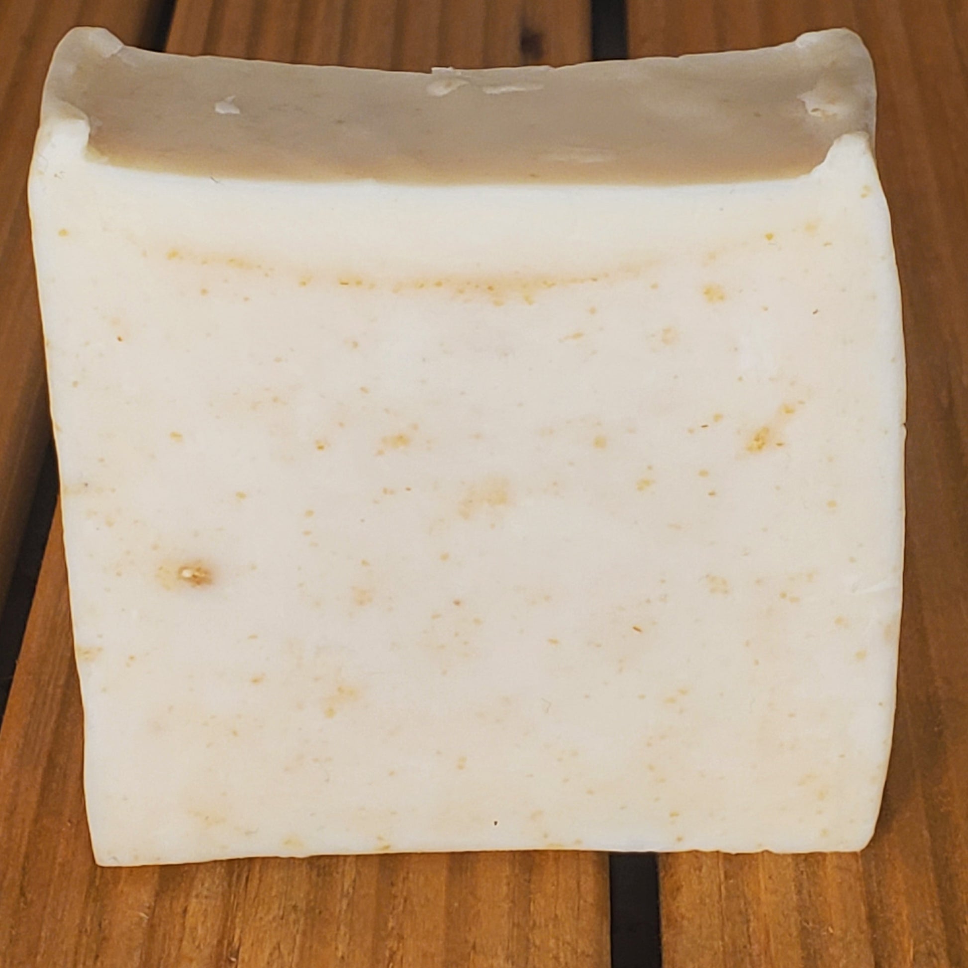 Block of white cheese on a wooden surface