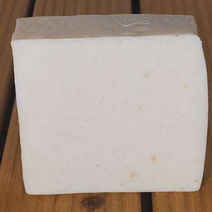 Block of white cheese on a wooden surface