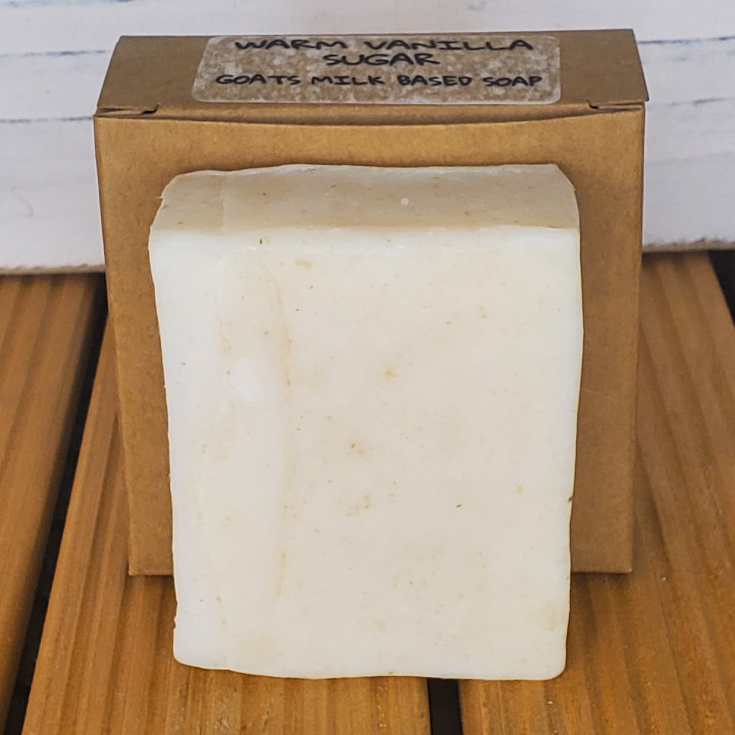 Bar of soap in a cardboard box on a wooden surface
