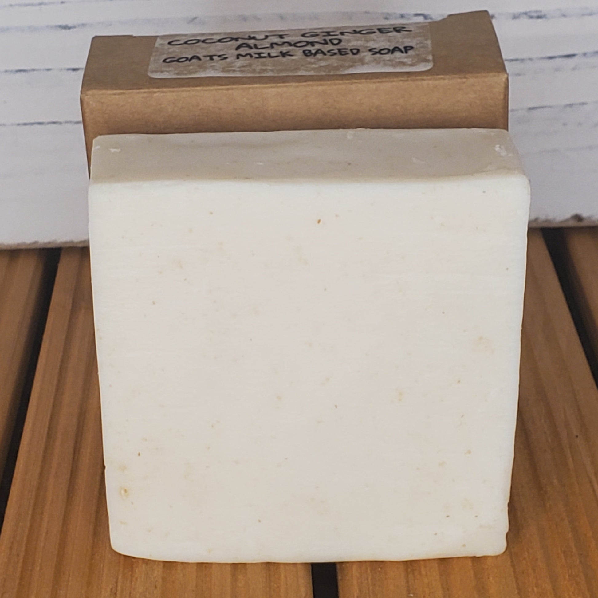 Bar of soap with a cardboard box on a wooden surface