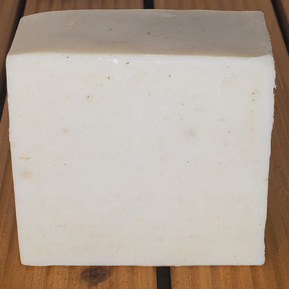 Block of white cheese on a wooden surface
