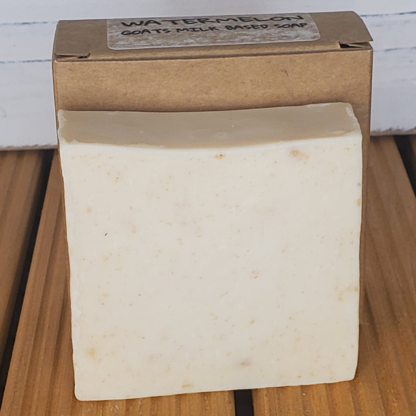 Bar of soap with a cardboard box on a wooden surface