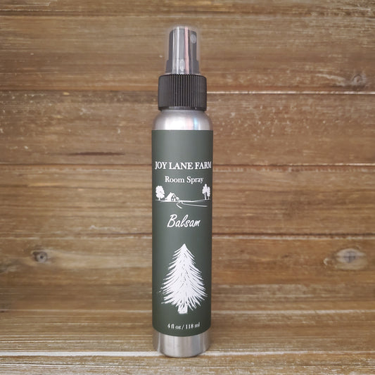 Room spray bottle labeled 'Joy Lane Farm' on a wooden background