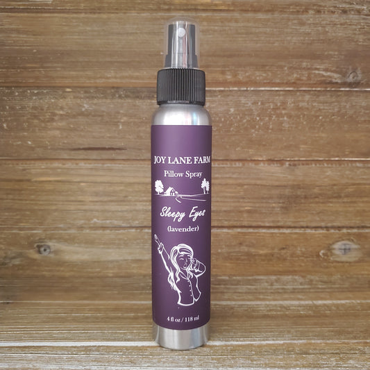 Pillow spray bottle with purple label on a wooden background