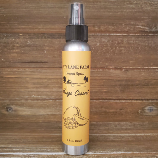 Room spray bottle with yellow label on a wooden background