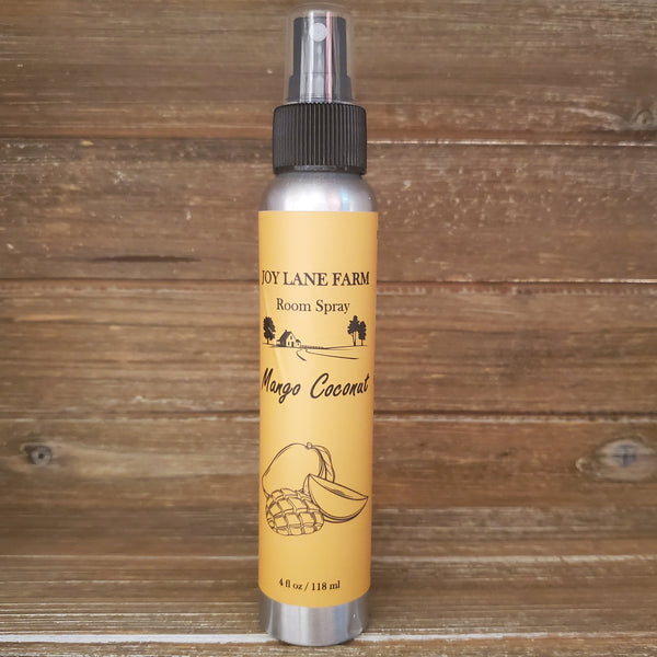 Room spray bottle with yellow label on a wooden background