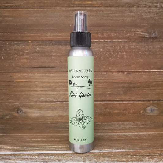 Room spray bottle with green label on a wooden surface